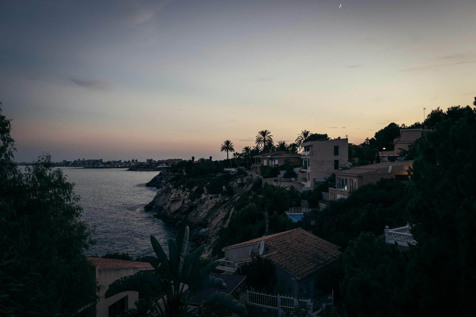 Luxury Mediterranean villa overlooking the sea at dusk
